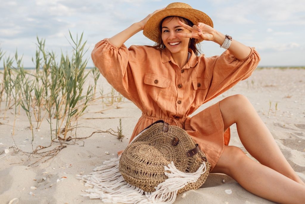 exited-brunette-woman-with-perfect-smile-having-fun-sunny-beach-sitting-white-sand-near-ocean.jpg